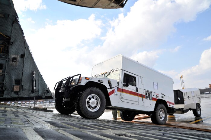 Marines from the II Marine Expeditionary Force, Chemical Biological Incident Response Force, Initial Response Force 'A' load CBIRF response vehicles onto a C-5 Galaxy bound for Japan, Apr. 1, 2011. Based at Naval Suport Facility Indian Head Maryland, CBIRF is a unit comprised of Marines and sailors specially trained to counter the effects of a chemical, biological, radiological, nuclear, and high-yeild explosive (CBRNE) incident. Usually, that intails being available to assist local, state and federal agencies with domestic emergency responses to CBRNE incidents. This is CBIRF's first  overseas deployment since it was stood up in 1996 in response to the sarin attack on Tokyo subway in 1995. (Released)