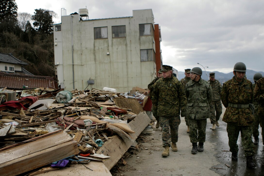 Lt. Gen. Kenneth J. Glueck, III Marine Expeditionary Force commanding general and Task Force 505 commander, tours Oshima Island during a clean-up operation here April 3.::r::::n::