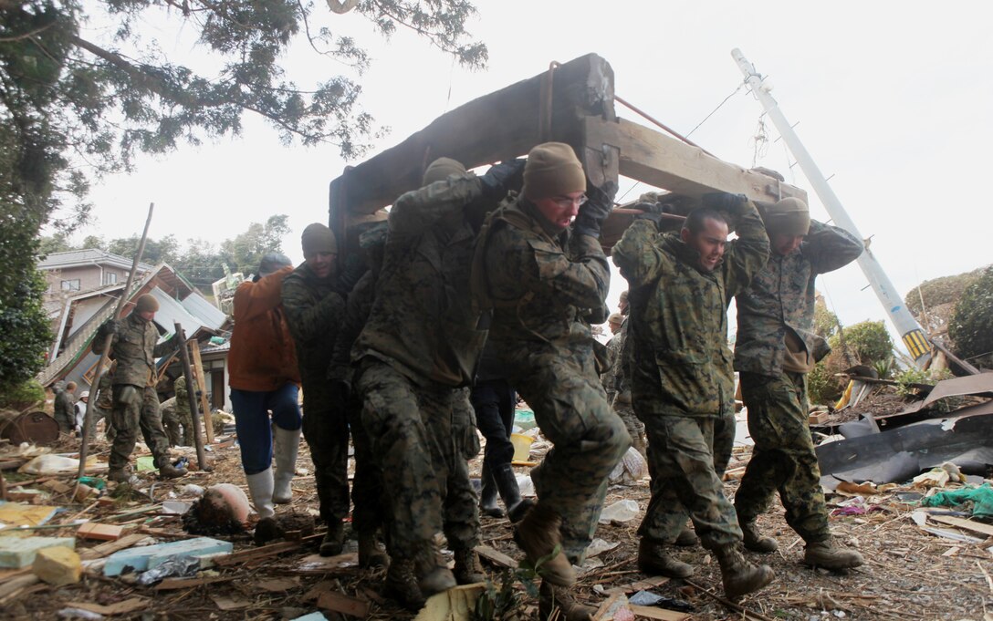 Heavy equipment with the 31st Marine Expeditionary Unit, moves debris out of the harbor during Operation Field Day, a debris-clearing and cleanup project designed to open access and area roads on the isolated island.  The 31st MEU is participating in Operation Tomodachi at the request of the Japanese government after the 9.0 earthquake and tsunami devastated the northeast coast of Japan.