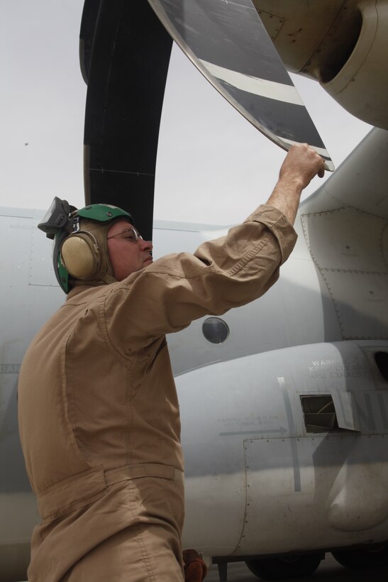Staff Sgt. Jacob A. Cobb, a KC-130J Hercules crew chief from Marine Aerial Refueler Squadron 252 inspects the propeller on a KC-130J Hercules after landing, April 3. The aircraft deployed in support of the Marine Medium Tiltrotor Squadron 266 retrograde received fuel at the air base prior to reaching their final destination in Souda Bay, Greece.