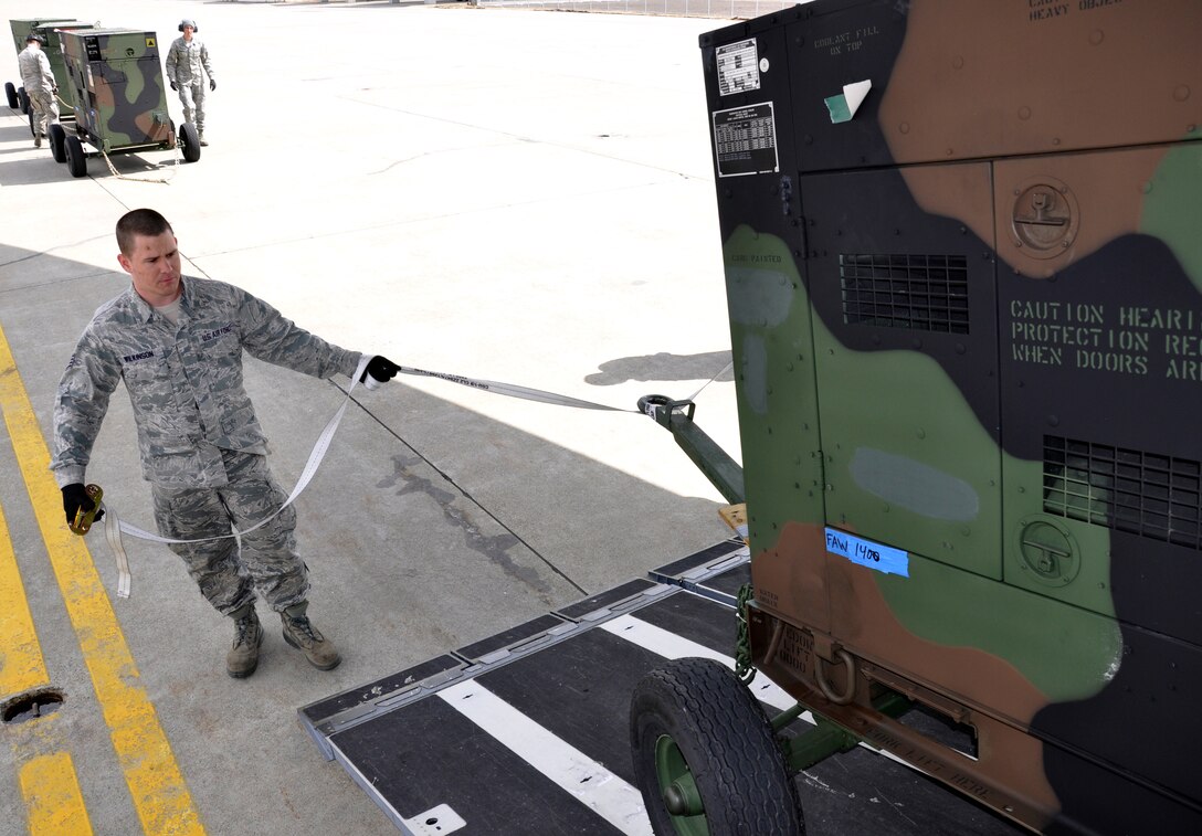 MISAWA AIR BASE, Japan – Staff Sgt. Christopher Wilkinson, 621st Contingency Response Wing aerial porter assigned to McGuire Air Force Base, N.J., guides a power generator as it is loaded onboard a U.S. Air Force C-17 Globemaster III assigned to Hickam Air Force Base, Hawaii, at the flightline here April 2. The aircraft, flown by members of the 517th Airlift Squadron assigned to Joint Base Elmendorf-Richardson, Alaska, took the generators to Yokota Air Base, Japan, in support of Operation Tomodachi. (U.S. Air Force photo by Senior Airman Joe McFadden/Released)