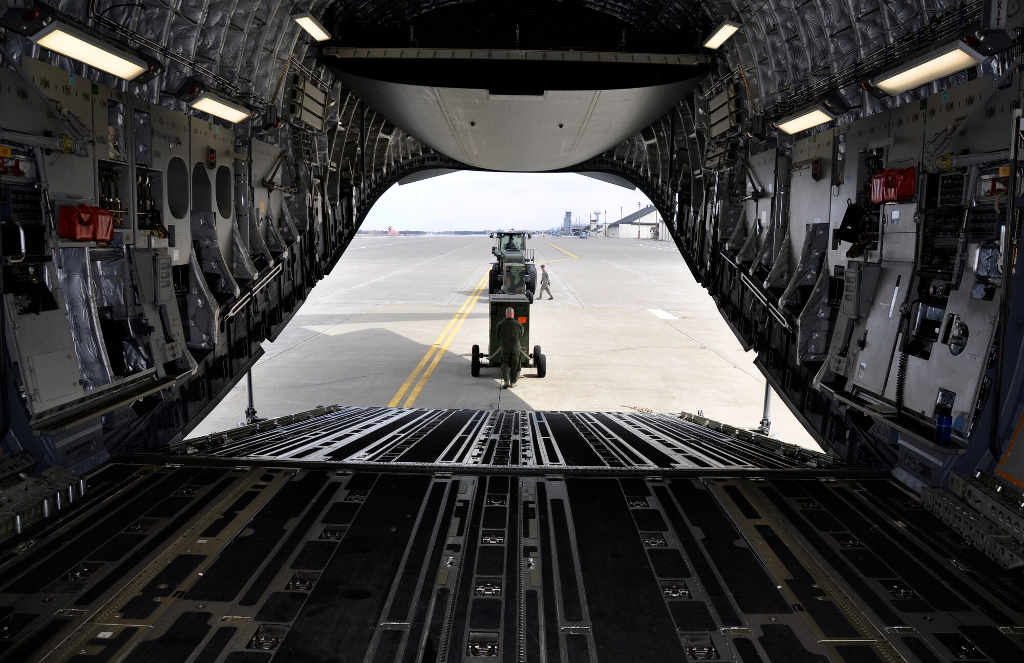 MISAWA AIR BASE, Japan – Tech. Sgt. Travis Duxbury, 517th Airlift Squadron loadmaster assigned to Joint Base Elmendorf-Richardson, Alaska, pulls a power generator onboard a U.S. Air Force C-17 Globemaster III at the flightline here April 2. The aircraft, assigned to Hickam Air Force Base, Hawaii, took 15 generators to Yokota Air Base, Japan, in support of Operation Tomodachi. (U.S. Air Force photo by Senior Airman Joe McFadden/Released)