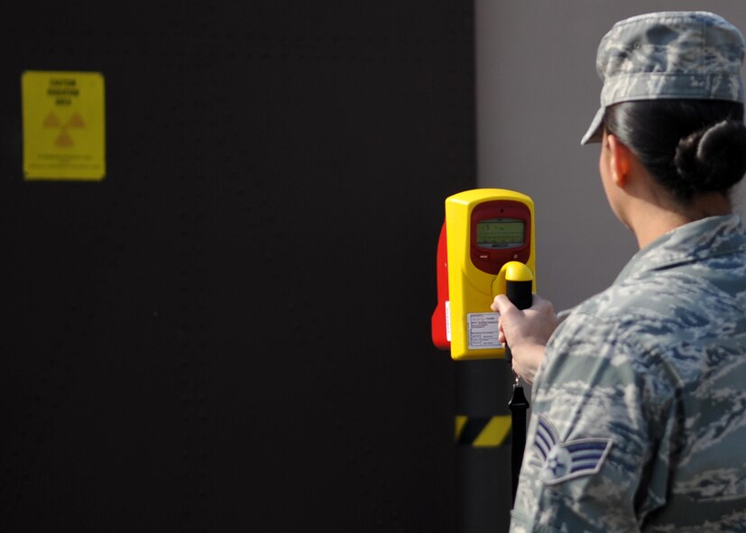 Senior Airman Sara Solis, 51st Aerospace Medicine Squadron, checks radiation
levels outside a non-destructive inspection flight building here March 24. The non-destructive inspection flight's job is to inspect support equipment, aircraft and weapon systems components for structural damage and flaws such as cracks, voids, heat damage and stress fractures. (U.S. Air Force photo/Senior Airman Evelyn Chavez)