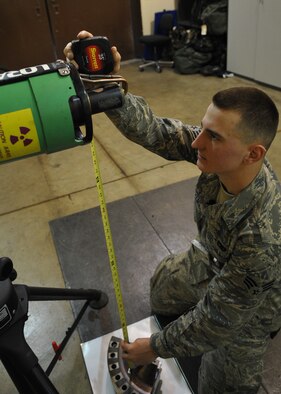 Senior Airman John Stevens, 51st Maintenance Squadron, measures the
distance between a Lorad 160 X-ray Machine and aircraft part being X-rayed here March 24. The non-destructive inspection flight's job is to inspect support equipment, aircraft and weapon systems components for structural damage and flaws such as cracks, voids, heat damage and stress fractures. One method these Airmen use is X-ray radiation because some flaws are so small they cannot be seen with the naked eye. (U.S. Air Force photo/Senior Airman Evelyn Chavez)
