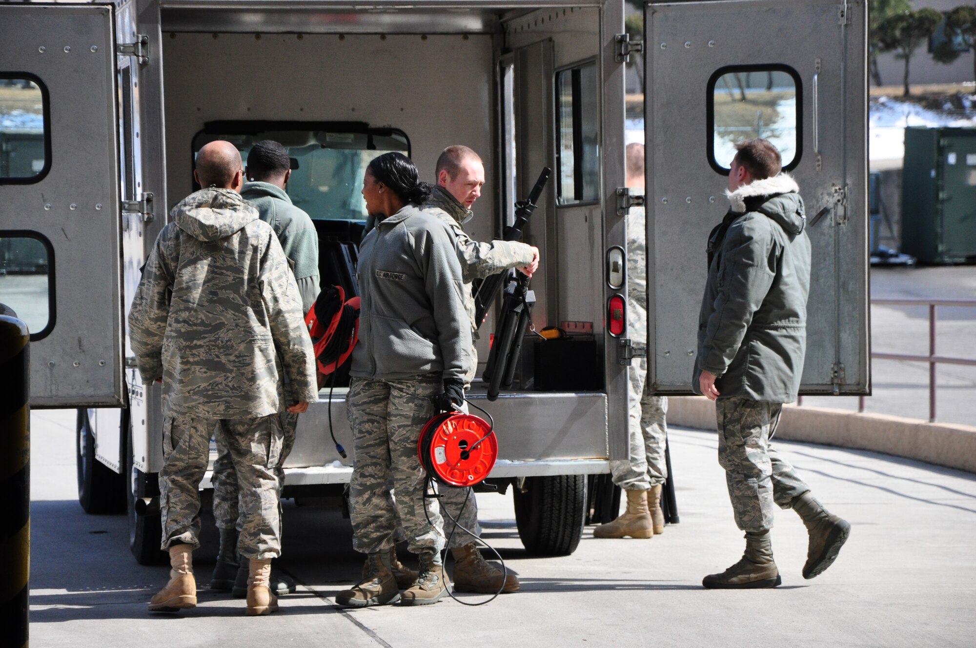 Airmen with the 51st Communications Squadron unload equipment for a commander's call here March 25. The 51st CS proved it was one of the best squadrons in the Air Force in 2010 by winning several major command-level Air Force awards. (U.S. Air Force photo/Staff Sgt. Chad Thompson)