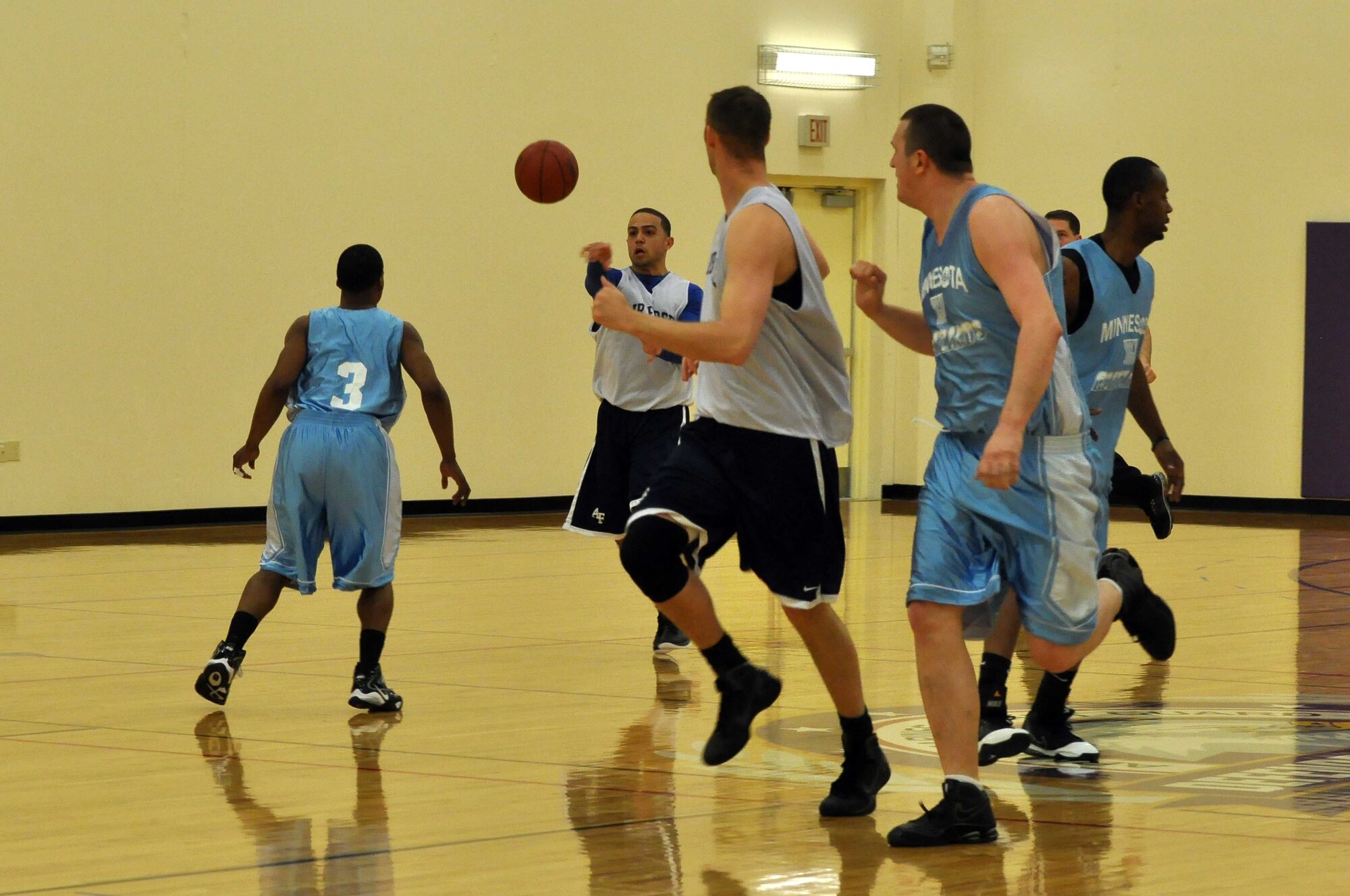 The Air Force basketball team (white) scrimmages the American Basketball Associations Minnesota Blizzards (blue) at the Minneapolis-St. Paul International Airport Air Reserve Station, Minn., April 2 2011. (Air Force Photo/TSgt Bob Sommer)