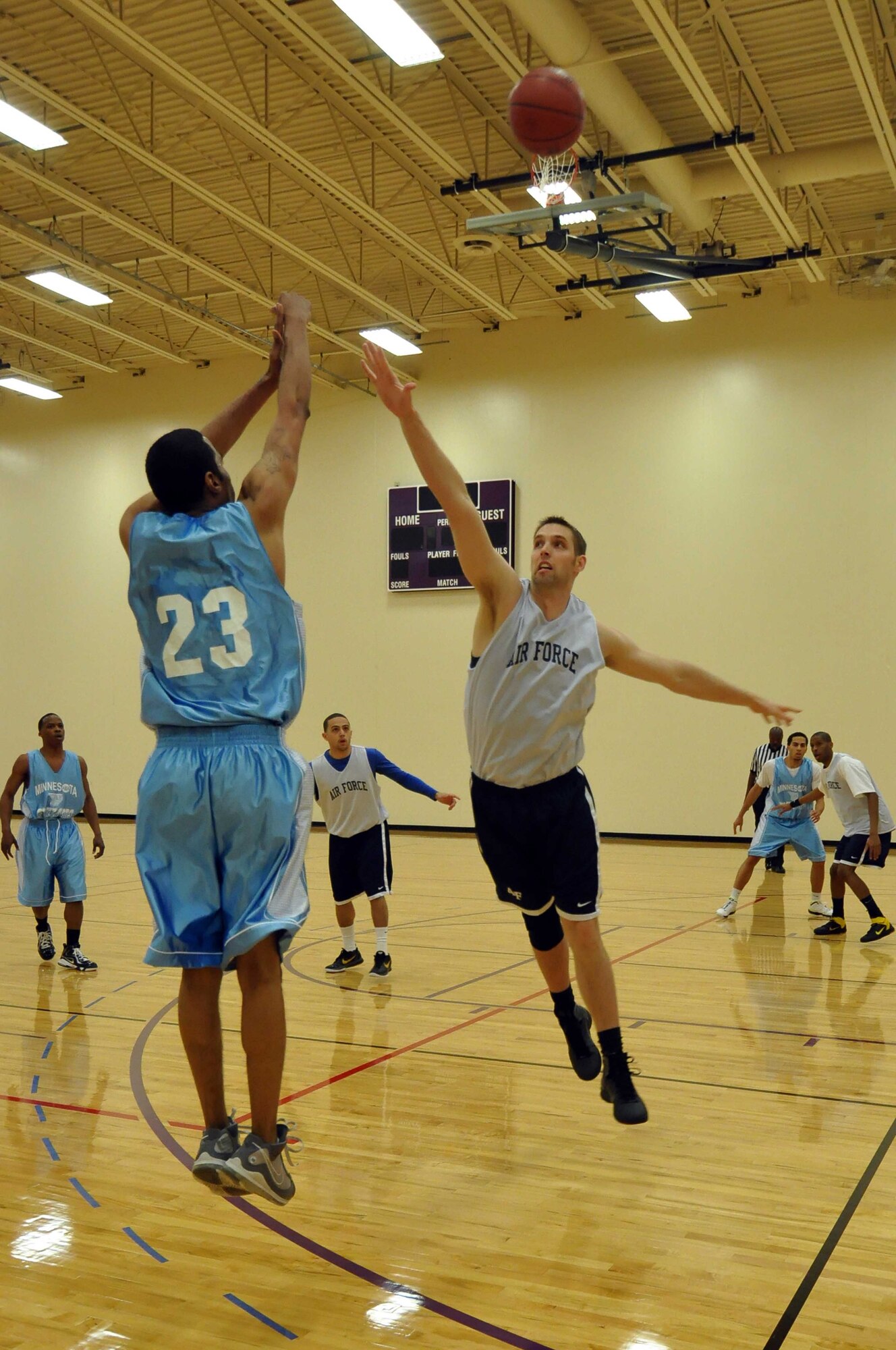 The Air Force basketball team (white) scrimmages the American Basketball Associations Minnesota Blizzards (blue) at the Minneapolis-St. Paul International Airport Air Reserve Station, Minn., April 2 2011. (Air Force Photo/TSgt Bob Sommer)