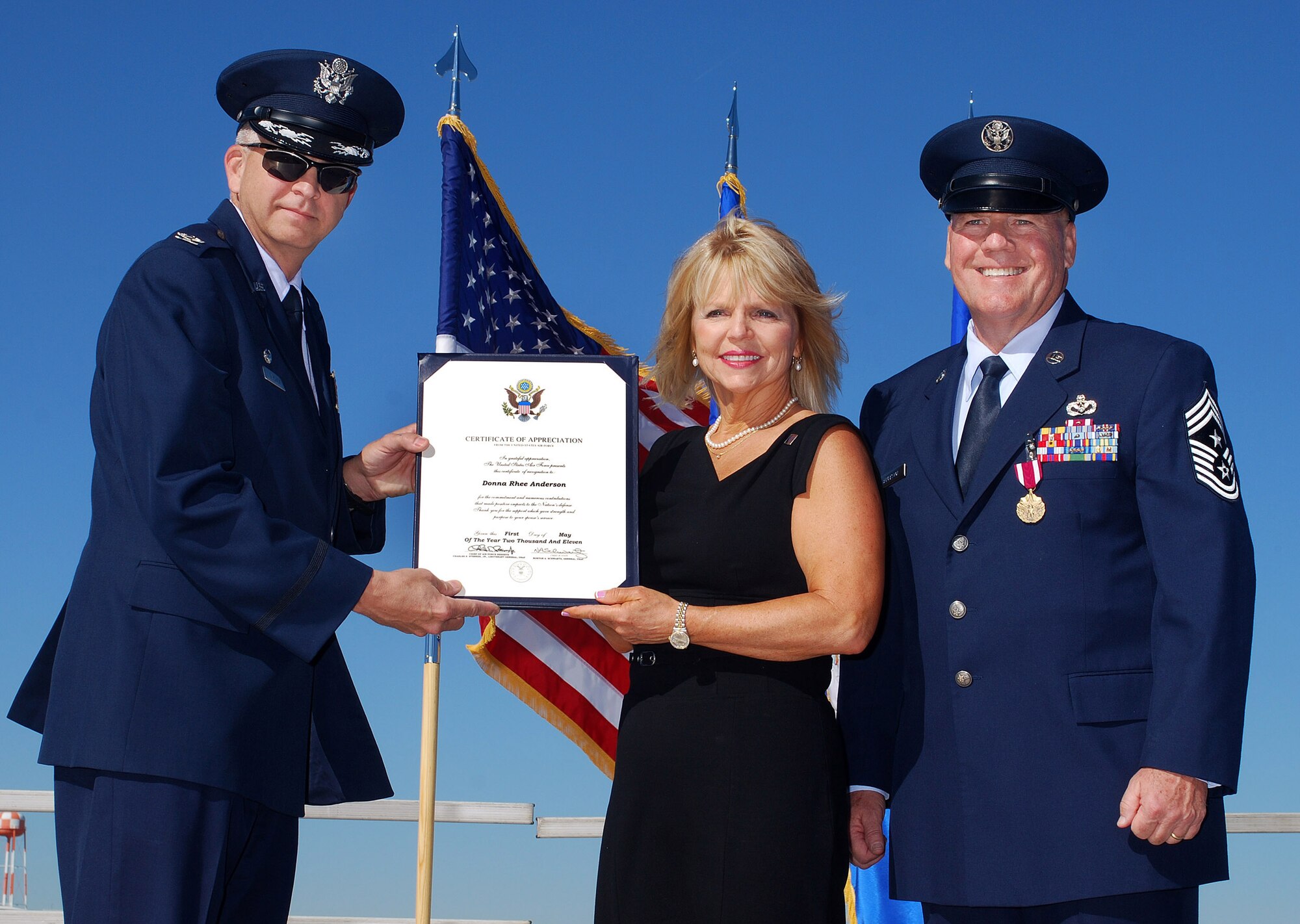 Col. Timothy E. Tarchick, 94th Airlift Wing Commander, presents a Certificate of Appreciation to Donna Anderson for her service in supporting Chief Master Sgt John M. Anderson, 94th Airlift Wing Command Chief, throughout their Air Force career; on the day of his retirement, after 33 years of active and reserve Air Force duty, Apr 3.   (U.S. Air Force photo/ Brad Fallin)