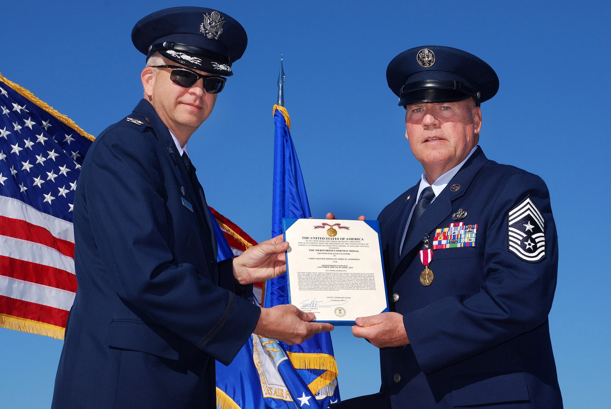 Col. Timothy E. Tarchick, 94th Airlift Wing Commander, presents the Air Force Meritorious Service Medal to Chief Master Sgt John M. Anderson, 94th Airlift Wing Command Chief, on the day of his retirement, after 33 years of active and reserve Air Force duty, Apr 3.   (U.S. Air Force photo/ Brad Fallin)