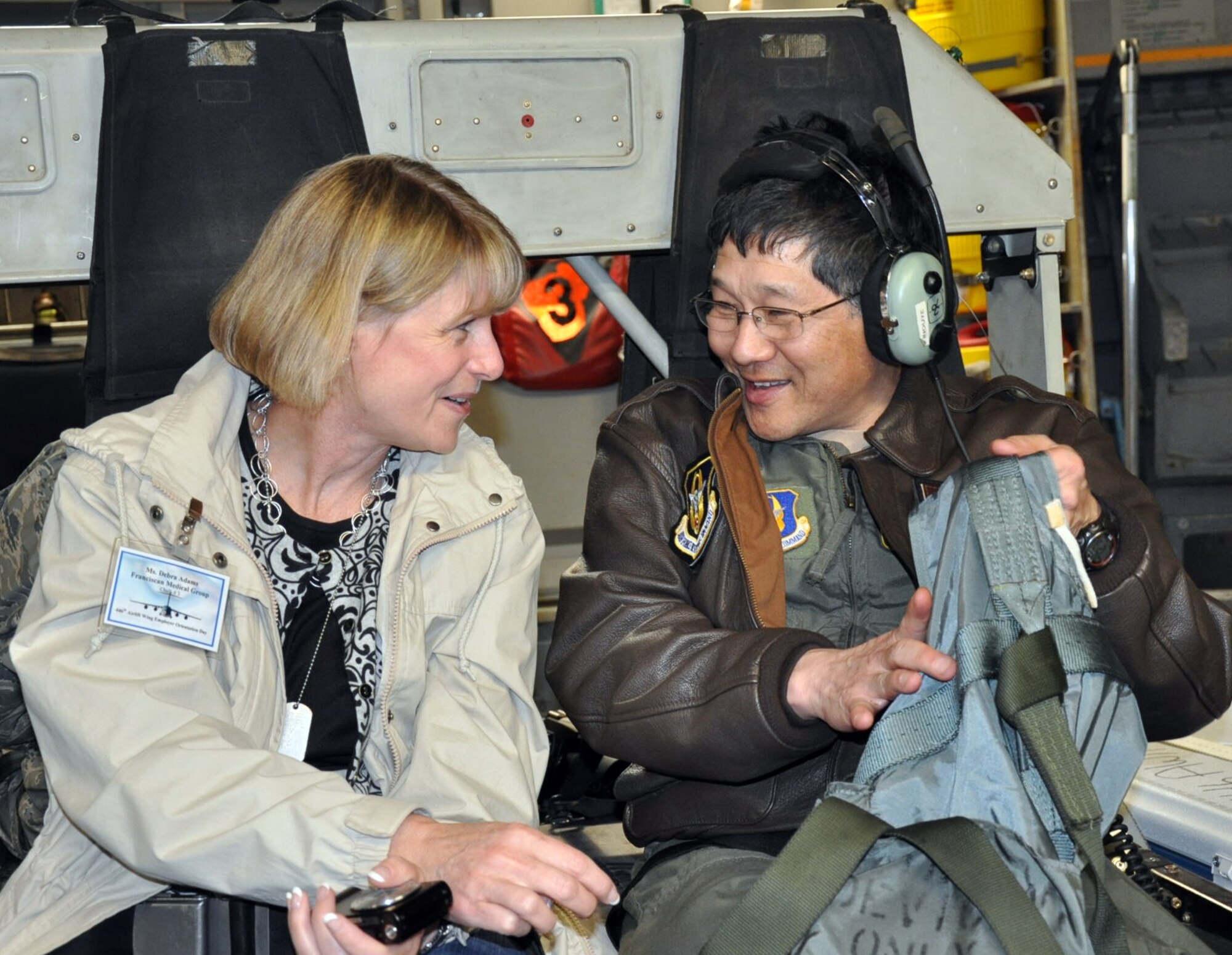 Col. Ted Inouye, 446th Aerospace Medicine Squadron flight surgeon here, shows his civilian employer Debra Adams, a manager with Franciscan Medical Group, how to use a personnel restraint harness during an orientation flight aboard a C-17 Globemaster III at McChord Field, April 2.  Colonel Inouye is also a general surgeon with the Franciscan Health System in his civilian practice.  The 446th Airlift Wing hosted civilian employers from throughout the Northwest during Employer Orientation Day, which gives employers the opportunity to learn how Reservists train and fight.  (U.S. Air Force photo by Staff Sgt. Elizabeth Moody)