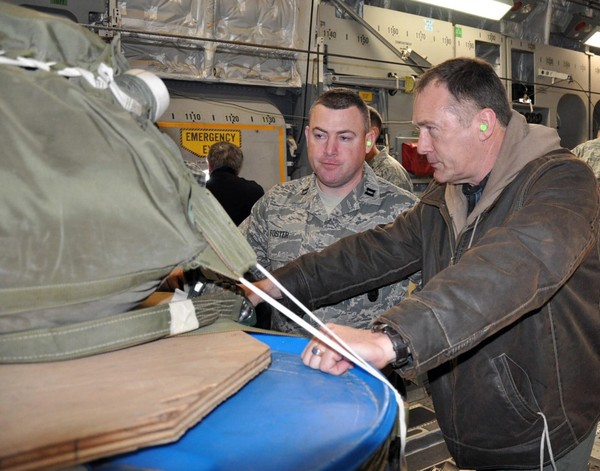 Capt. Nate Foster, 446th Security Forces Squadron operations officer here, discusses combat offloads with Sheriff Gene Dana, Kittitas County, Wash., during an employer orientation flight aboard a C-17 Globemaster III.  Capt. Foster is also a deputy with Kittitas County in his civilian job.  During the April 2 event at McChord Field, Wash., employers from the Northwest got a glimpse of the 446th Airlift Wing mission and learned how teams of specialists train and fight.  (U.S. Air Force photo by Staff Sgt. Elizabeth Moody)