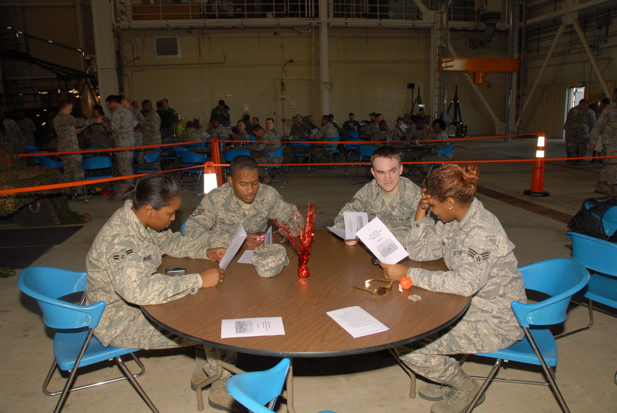 Members of the 164th AW read the rules of the mess before the start of the Combat Dining-In