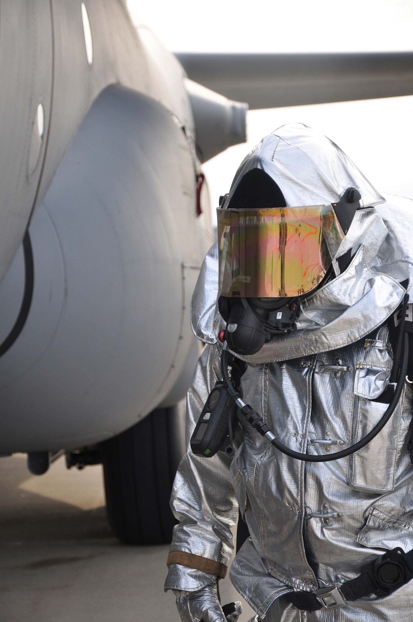 A firefighter from the 934th Airlift Wing, awaits instructions during a simulated C-130 Hercules fire April 3 2011. (Air Force Photo/TSgt Bob Sommer)