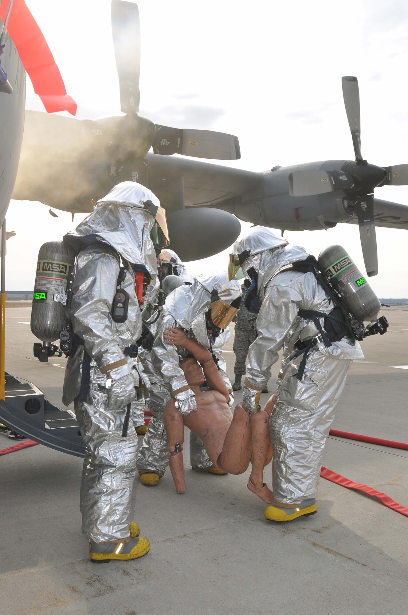 Firefighters from the 934th Airlift Wing, extract a "victim" from a simulated C-130 Hercules fire April 3 2011. (Air Force Photo/TSgt Bob Sommer)