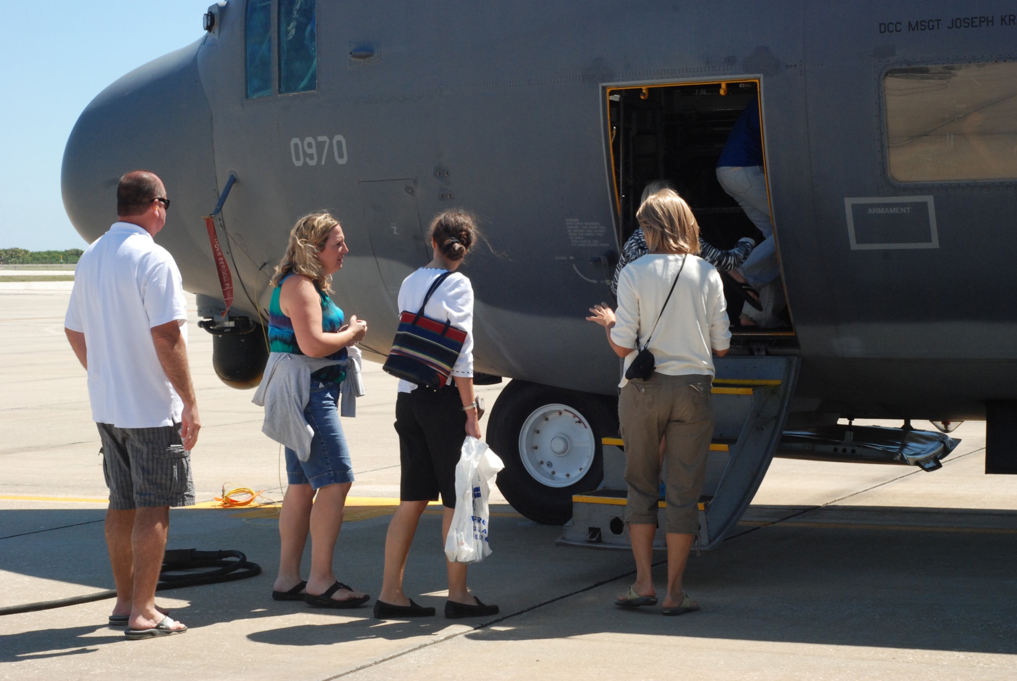 PATRICK AIR FORCE BASE, Fla. -- Parents of Adventure Maidens, a Y organization, board a HC-130 P/N King refueling aircraft as they tour the interior. The group of parents and  children explored both the HC-130 and the HH-60G Pave Hawk helicopter while on a tour of the Air Force Reserve's 920th Rescue Wing here. (U.S. Air Force photo/Airman First Class Natasha Dowridge)