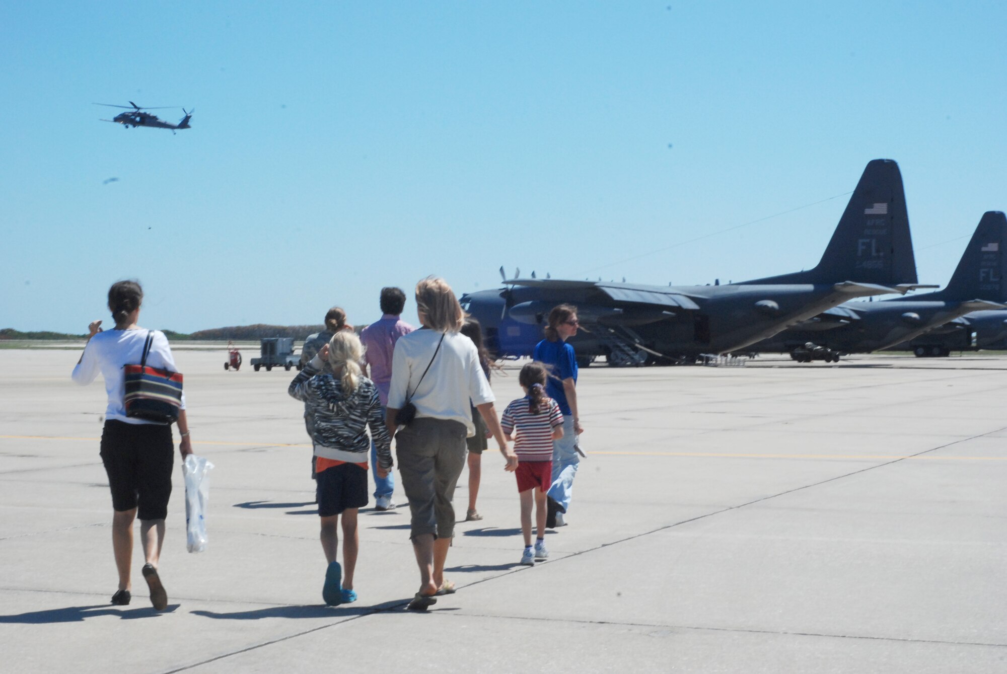 PATRICK AIR FORCE BASE, Fla., -- The Adventure Maidens walk towards the HC-130P/N King refueling aircraft. The group of mothers and fathers went on tour of the 920th Rescue Wing as a way to show how female Airman also serve in non-traditional jobs. The HC-130P/N is the only dedicated fixed-wing combat search and rescue platform in the Air Force inventory.(U.S. Air Force photo/Airman First Class Natasha Dowridge)