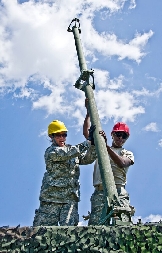 Members of the 728th Air Control Squadron stand up VHF and UHF antennas at Duke Field April 1 prior to a week-long exercise.  (U.S. Air Force photo/Tech. Sgt. Samuel King Jr.)