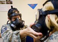 Master Sgt. Jessica Epps, 919th Force Support Squadron, performs a gas mask filter swap with her partner at a gas mask familiarization class during the 919th Special Operations Wing’s first four-day training weekend.  Training classes, such as chemical warfare defense and self-aid and buddy care were offered April 1 to ensure Airmen were able to accomplish as much training as possible.  (U.S. Air Force photo/Tech. Sgt. Samuel King Jr.)
