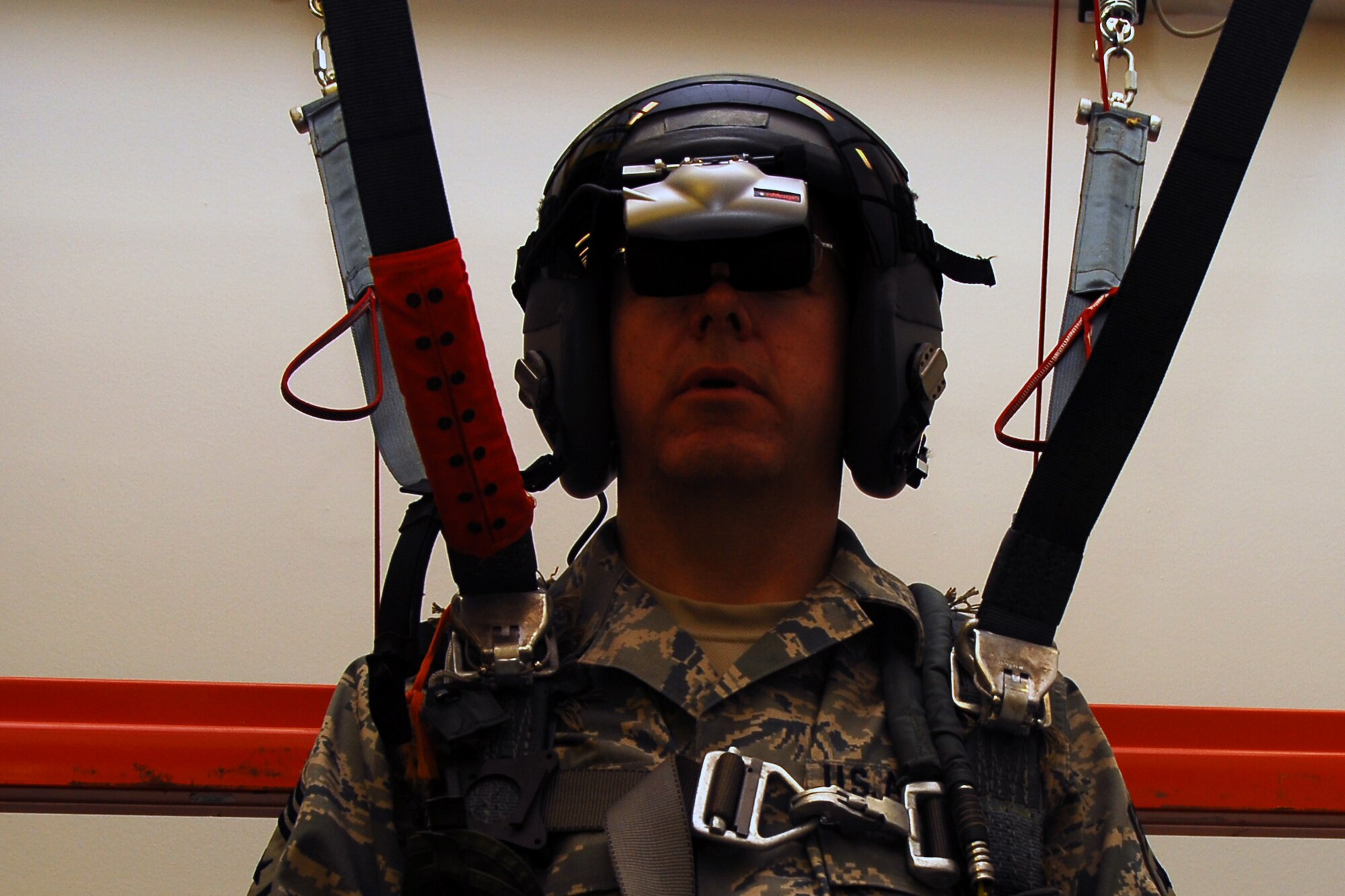 Chief Master Sergeant Steven Larwood, 22nd Air Force command chief, looks into his virtual helmet to locate his landing target while strapped into the 403rds Aircrew Flight Equipment's parachute simulator. This is one of the many shops the chief visited upon his visit to the 403rd Wing. (U.S. Air Force Photo by Senior Airman Tabitha Dupas)