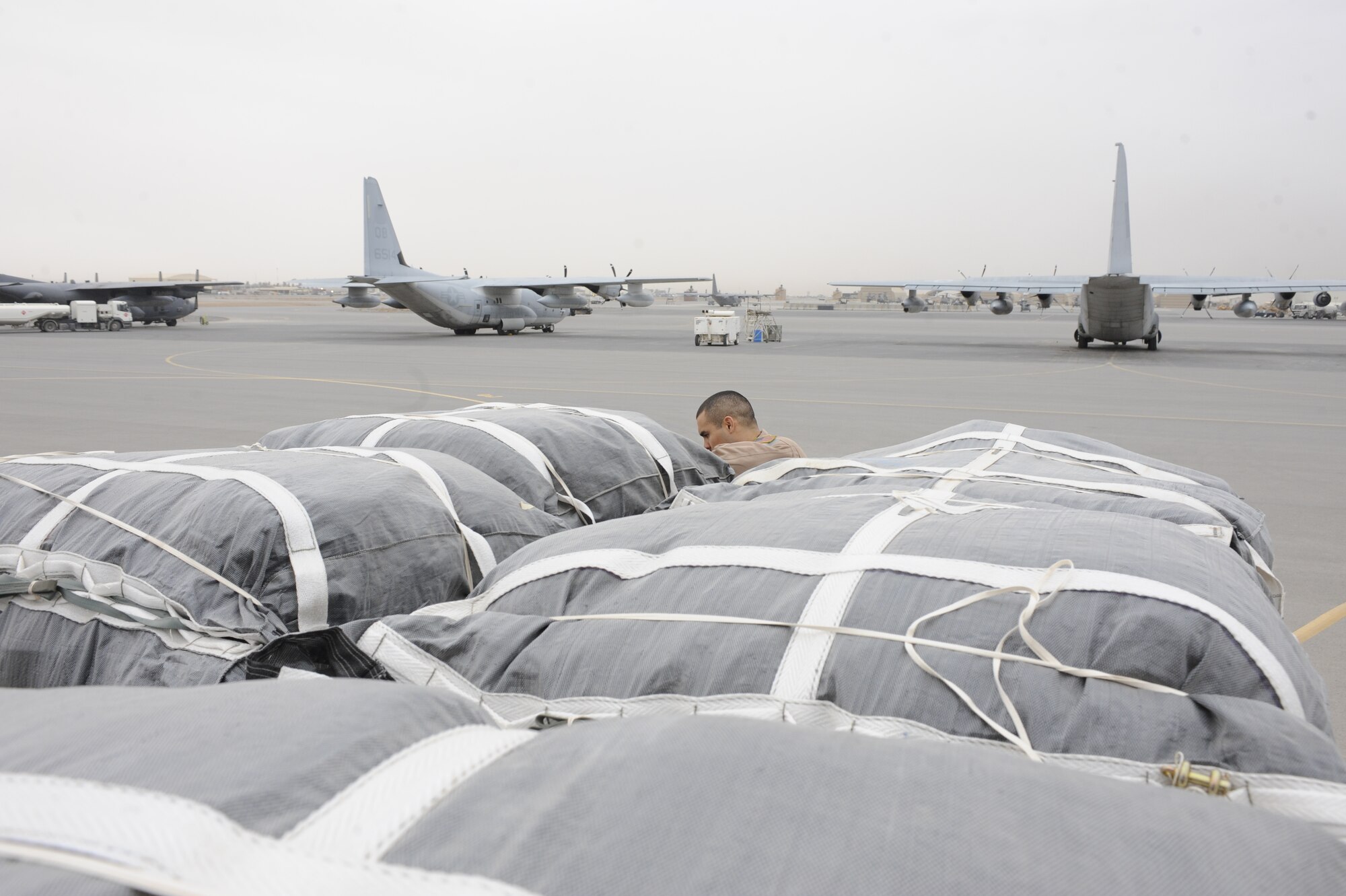 Bundles of supplies are loaded onto a 772nd Expeditionary Airlift Squadron C-130J Hercules at Kandahar Airfield, Afghanistan.  A parachute is attached to each bundle allowing a 99 percent accuracy of the airdropped bundles to be recovered undamaged by ground troops needing the supplies.  In March 2011, the 772nd EAS dropped more than 1.5 million pounds of supplies to troops across Afghanistan. (U.S. Air Force photo/Senior Airman Willard E. Grande II)