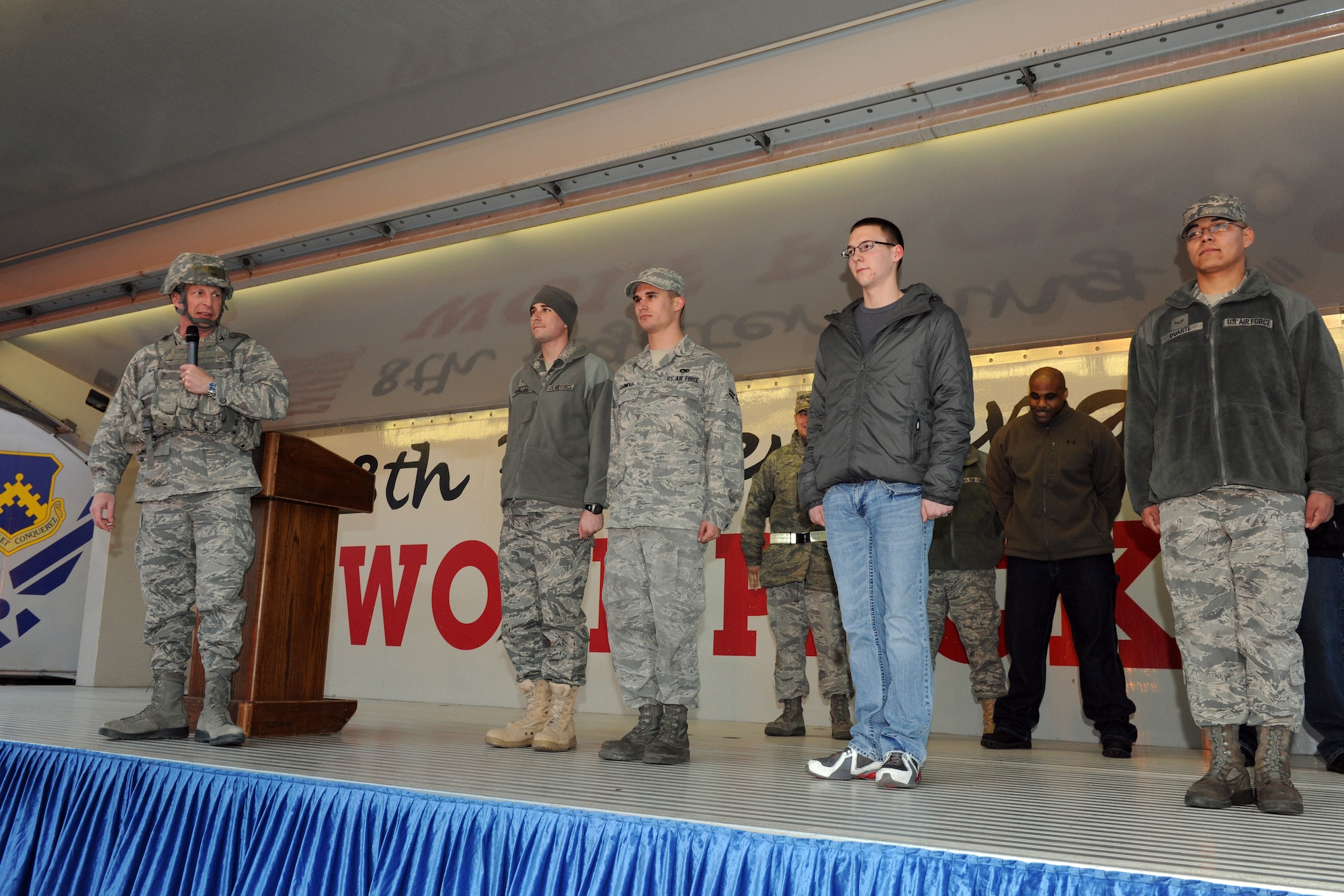 KUNSAN AIR BASE, Republic of Korea -- Col. John Dolan, 8th Fighter Wing commander, holds four Wolf Pack Airmen First Class at attention before announcing their selection to receive Senior Airman Below-the-Zone during a pep rally March 31 for the start of the Pacific Air Force Operational Readiness Inspection. The four Airmen First Class are Matthew Phillips, 8th Logistics Readiness Squadron; Brandon Garneau, 8th Aircraft Maintenance Squadron; Jason Devore, 8th LRS; and Robert Duarte, 8th LRS. (U.S. Air Force photo/Tech. Sgt. Jonathan Pomeroy)