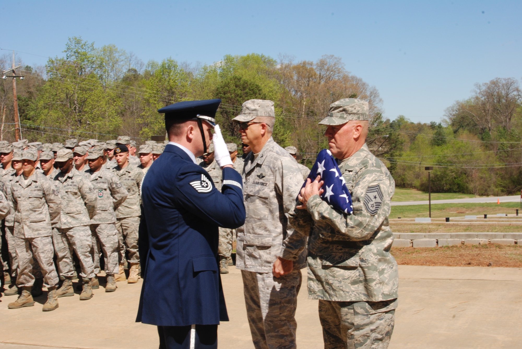 Tech. Sgt. Bryan Reed, Dobbins Base Honor Guardsman, renders a final salute after the presentation of the American Flag to Chief Master Sgt. John Anderson, 94th Airlift Wing Command Chief, during the April unit training assembly.  Chief Anderson accepted the flag in celebration of his retirement after 33 years of service with the Air Force.  (U.S. Air Force photo/Master Sgt. Stan Coleman)
