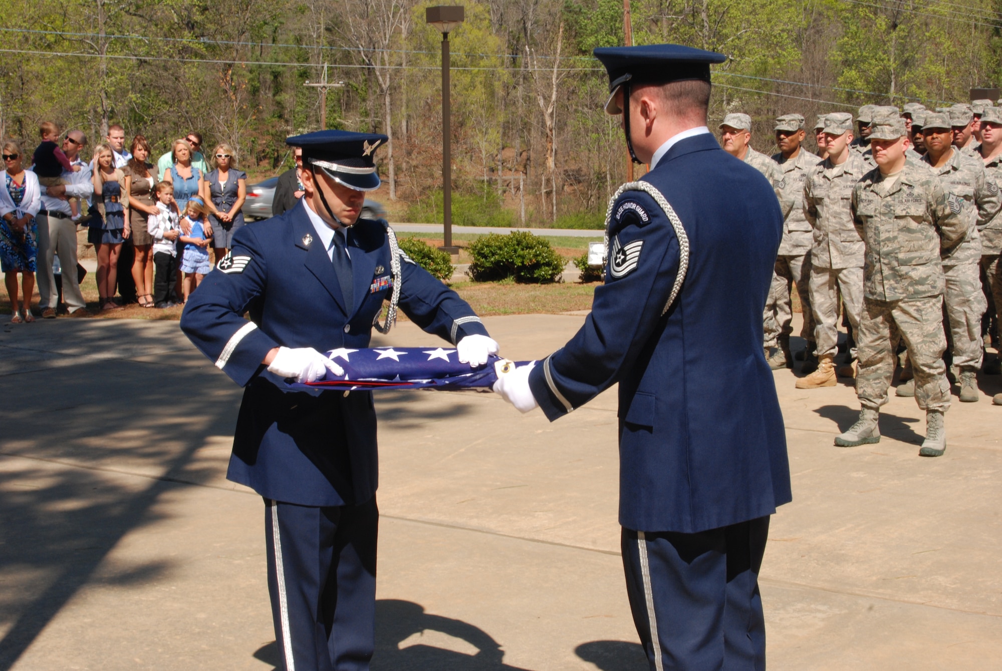 Staff Sgt. Joseph Saldivar and Tech. Sgt. Bryan Reed, Dobbins Base Honor Guardsmen, execute precision and attention to detail in the performance of the flag folding ceremony for Chief Master Sgt. John Anderson, 94th Airlift Wing Command Chief. Chief Anderson accepted the flag in celebration of his final unit training assembly with the 94th Airlift Wing and his retirement.  (U.S. Air Force photo/Master Sgt. Stan Coleman)