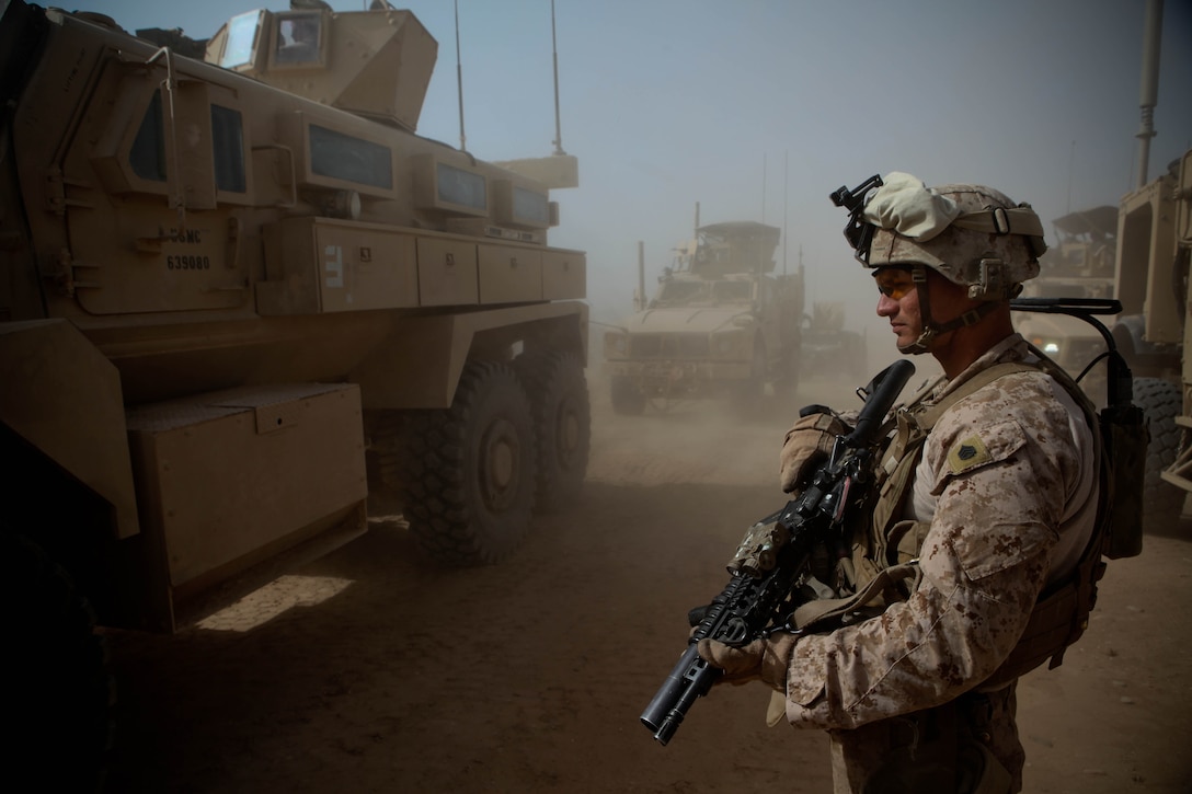 Staff Sgt. Maximo Veliz, the Personal Security Detachment commander for 3rd Battalion, 9th Marine Regiment, provides security for his team while they park their vehicles during a movement through Marjah District, April 3. The 29-year-old Hialeah, Fla., native is currently deployed in support of Operation Enduring Freedom. The PSD provides security for the battalion commander and VIPs visiting the unit’s area of operation, while also building relationships with local citizens when they go out.