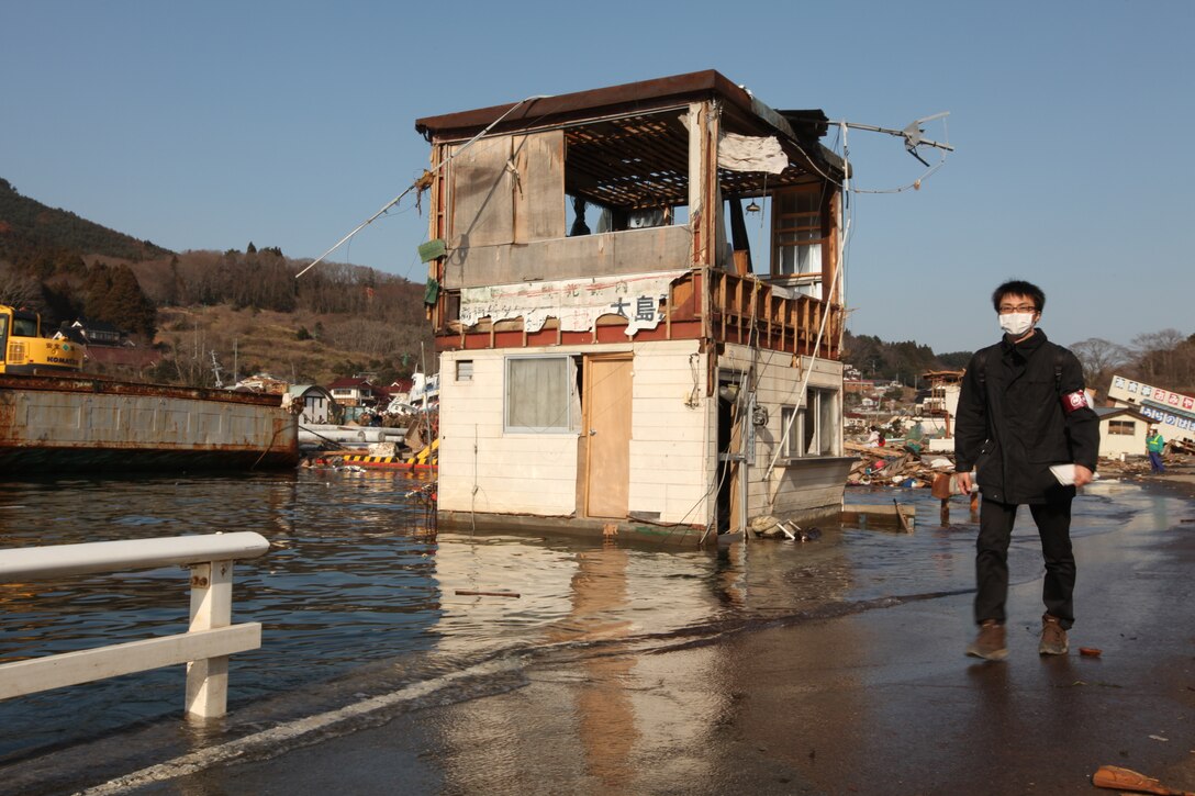 A Japanese citizen walks by a damaged building at Uranohama Port in the aftermath of the earthquake and subsequent tsunami that struck the region.  The 31st MEU's involvement in Operation Tomodachi is part of a larger U.S. government response, after a 9.0 earthquake and subsequent tsunami struck Japan causing widespread damage.  The 31st MEU is ready to support our Japanese partners and to provide assistance when called upon.