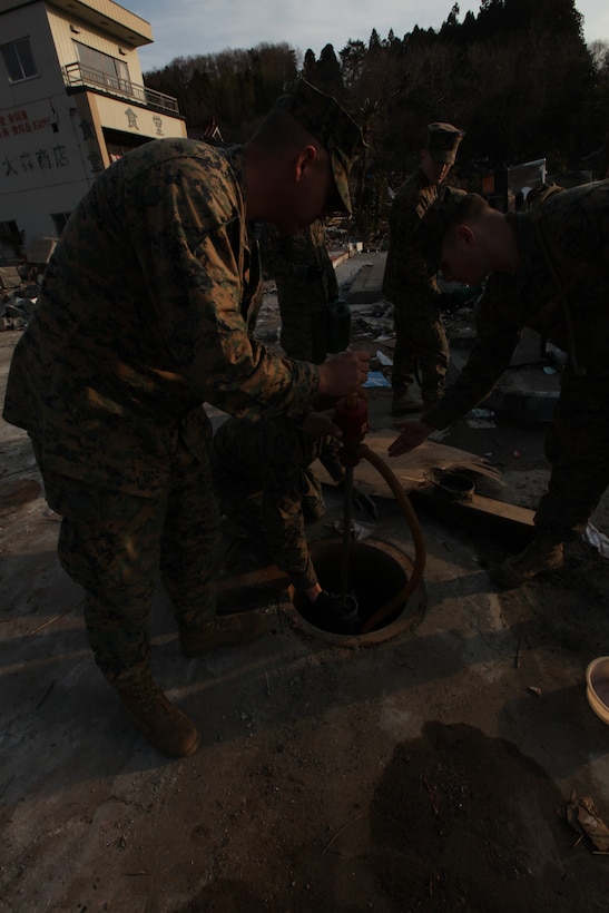 Marines with Battalion Landing Team 2nd Battalion, 5th Marines, 31st Marine Expeditionary Unit, siphon gasoline during a humanitarian assistance/disaster relief mission at Uranohama Port, April 1. The mission was in support of Operation Tomodachi.  The 31st MEU's involvement is part of a larger U.S. government response, after a 9.0 earthquake and subsequent tsunami struck Japan causing widespread damage.  The 31st MEU is ready to support our Japanese partners and to provide assistance when called upon.