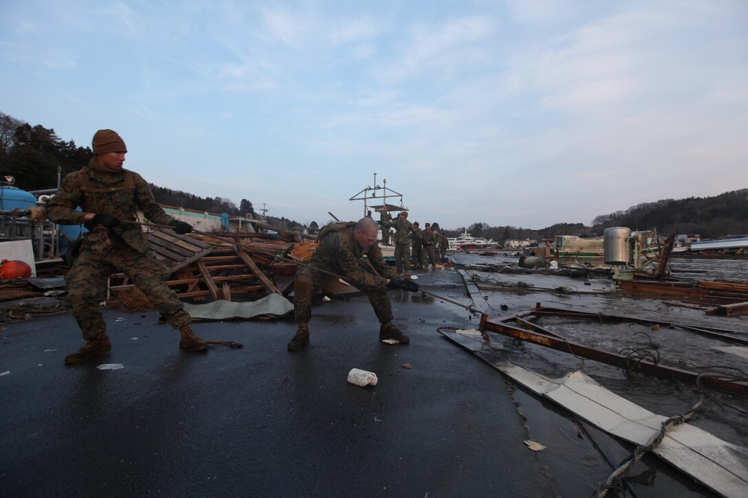 Marines with Battalion Landing Team 2nd Battalion, 5th Marines, 31st Marine Expeditionary Unit, pull debris from the water during a humanitarian assistance/disaster relief mission at Uranohama Port, April 1. The mission was in support of Operation Tomodachi.  The 31st MEU's involvement is part of a larger U.S. government response, after a 9.0 earthquake and subsequent tsunami struck Japan causing widespread damage.  The 31st MEU is ready to support our Japanese partners and to provide assistance when called upon.