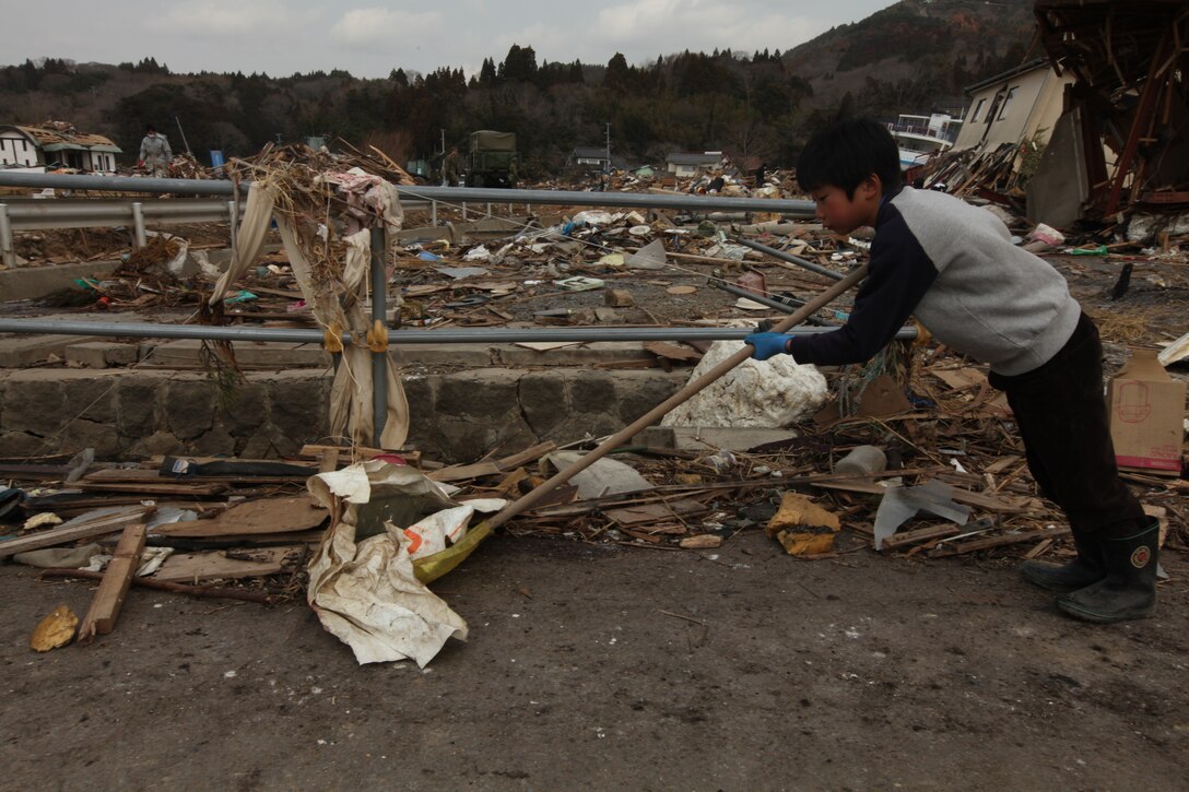 A Japanese boy clears debris with a shovel at Uranohama Port  in the aftermath of the earthquake and subsequent tsunami that struck the region.  The 31st MEU's involvement in Operation Tomodachi is part of a larger U.S. government response, after a 9.0 earthquake and subsequent tsunami struck Japan causing widespread damage.  The 31st MEU is ready to support our Japanese partners and to provide assistance when called upon.
