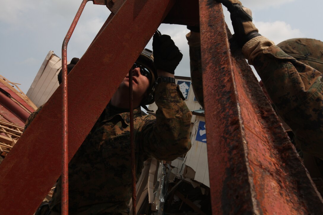 Marines with Battalion Landing Team 2nd Battalion, 5th Marines, 31st Marine Expeditionary Unit, disassemble the wall framing of a house during a humanitarian assistance/disaster relief mission at Uranohama Port, April 2. The mission was in support of Operation Tomodachi.  The 31st MEU's involvement is part of a larger U.S. government response, after a 9.0 earthquake and subsequent tsunami struck Japan causing widespread damage.  The 31st MEU is ready to support our Japanese partners and to provide assistance when called upon.