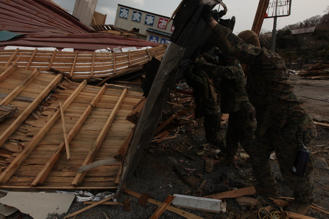 Marines with Battalion Landing Team, 2nd Battalion, 5th Marines, 31st Marine Expeditionary Unit, move part of a wall from a destroyed house during a humanitarian assistance/disaster relief mission at Uranohama Port, April 2. The mission was in support of Operation Tomodachi.  The 31st MEU's involvement is part of a larger U.S. government response, after a 9.0 earthquake and subsequent tsunami struck Japan causing widespread damage.  The 31st MEU is ready to support our Japanese partners and to provide assistance when called upon.