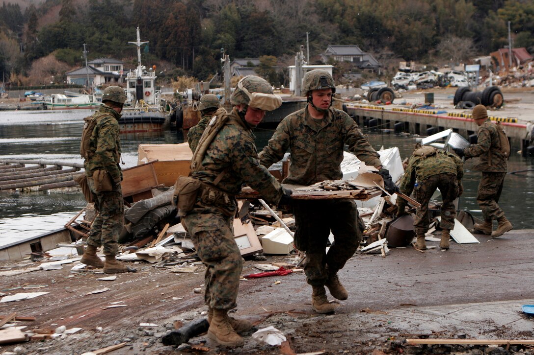 Marines with Company G, Battalion Landing Team 2nd Battalion, 5th Marines, 31st Marine Expeditionary Unit, carry debris from a destroyed house off of the road, April 4. As part of Operation Tomodachi, the 31st MEU is ready to support our Japanese partners and to provide assistance when called upon.