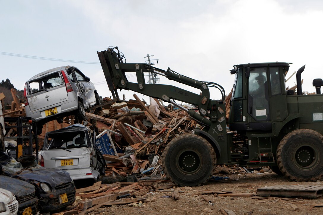 A Marine with Company G, Battalion Landing Team 2nd Battalion, 5th Marines, 31st Marine Expeditionary Unit, moves a destroyed car during Operation “Field Day”, April 4. As part of Operation Tomodachi, the 31st MEU is ready to support our Japanese partners and to provide assistance when called upon.