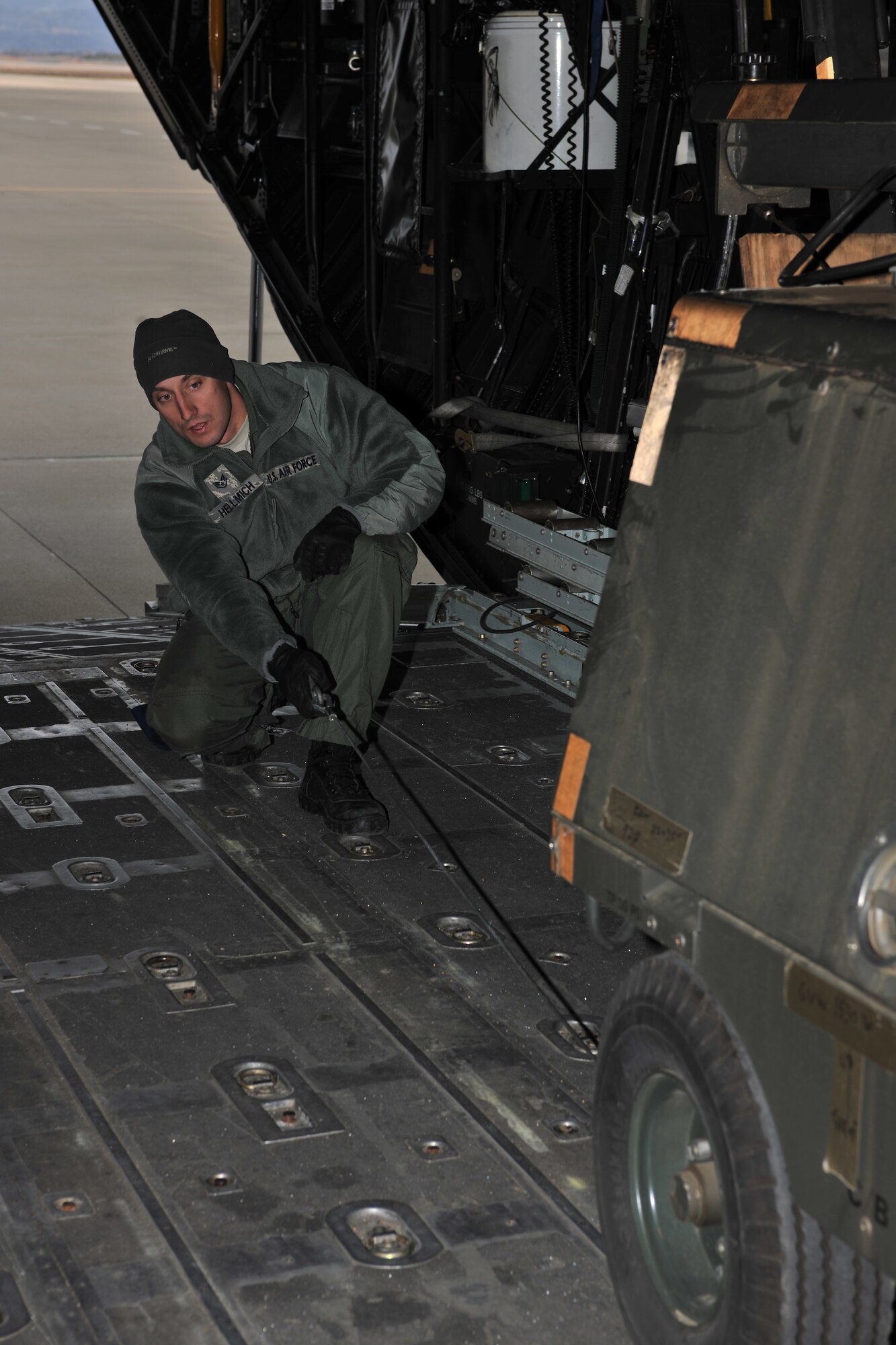 SENDAI AIRPORT, Japan -- Staff Sgt. Brian Hellmich, 17th Special Operations Squadron radio operator from Kadena Air Base, loads flood lights onto a C-130 Hercules aircraft at Sendai Airport April 3. Sergeant Hellmich, a native of Algona, Iowa, is just one of 14,000 U.S. personnel working to support relief efforts for Operation Tomodachi. (U.S. Air Force photo/Master Sgt. Kimberly Spinner) 