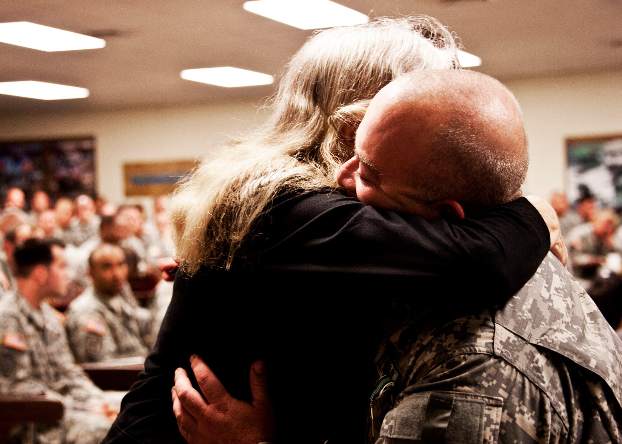 Specialist Steven Brooks, 6th Ranger Training Battalion medic, receives a hug from Brianna Baker's mother after being awarded the Army Commendation Medal March 31.  He and Specialist David Wallace received recognition for their heroic efforts in helping to save the Ms. Baker's life after a car accident on State Road 85.  (U.S. Air Force photo/Samuel King Jr.)
