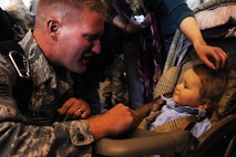 MINOT AIR FORCE BASE, N.D. -- Senior Airman Daniel Duplesis, 5th Maintenance Squadron air ground equipment specialist, is greeted by his family during the 5th Bomb Wing redeployment here April 4. Minot’s 69th Bomb Squadron and 5th Bomb Wing personnel deployed to Andersen AFB, Guam last November in support of U.S. Pacific Command’s Continuous Bomber Presence. This was the 69th BS’ first deployment since it’s reactivation in September 2009 and the first major combat deployment of aircraft and personnel since World War II. (U.S. Air force photo/ Airman 1st Class Aaron-Forrest Wainwright) 