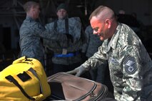MINOT AIR FORCE BASE, N.D. -- Chief Master Sgt. Bryn LePine, 5th Mission Support Group command chief and other Logistics Readiness members, unload returning deployers’ luggage during the 5th Bomb Wing Airmen redeployment here April 4. Minot’s 69th Bomb Squadron and 5th Bomb Wing personnel deployed to Andersen AFB, Guam last November in support of U.S. Pacific Command’s Continuous Bomber Presence. This was the 69th BS’ first deployment since it’s reactivation in September 2009 and the first major combat deployment of aircraft and personnel since World War II. (U.S. Air force photo/ Airman 1st Class Aaron-Forrest Wainwright)