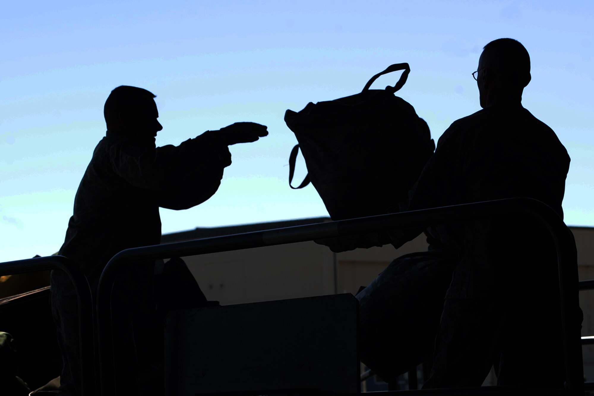 MINOT AIR FORCE BASE, N.D. -- Chief Master Sgt. Bryn LePine, 5th Mission Support Group command chief and Lt. Col Christopher Trotter 5th Logistics Readiness Squadron commander, unload returning deployers’ luggage during the 5th Bomb Wing Airmen redeployment here April 4. Minot’s 69th Bomb Squadron and 5th Bomb Wing personnel deployed to Andersen AFB, Guam last November in support of U.S. Pacific Command’s Continuous Bomber Presence. This was the 69th BS’ first deployment since it’s reactivation in September 2009 and the first major combat deployment of aircraft and personnel since World War II. (U.S. Air force photo/ Airman 1st Class Aaron-Forrest Wainwright)

