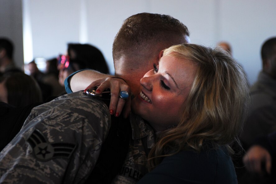 MINOT AIR FORCE BASE, N.D. -- Senior Airman Daniel Duplesis, 5th Maintenance Squadron air ground equipment specialist, is greeted by his family during the 5th Bomb Wing redeployment here April 4. Minot’s 69th Bomb Squadron and 5th Bomb Wing personnel deployed to Andersen AFB, Guam last November in support of U.S. Pacific Command’s Continuous Bomber Presence. This was the 69th BS’ first deployment since it’s reactivation in September 2009 and the first major combat deployment of aircraft and personnel since World War II. (U.S. Air force photo/ Airman 1st Class Aaron-Forrest Wainwright) 