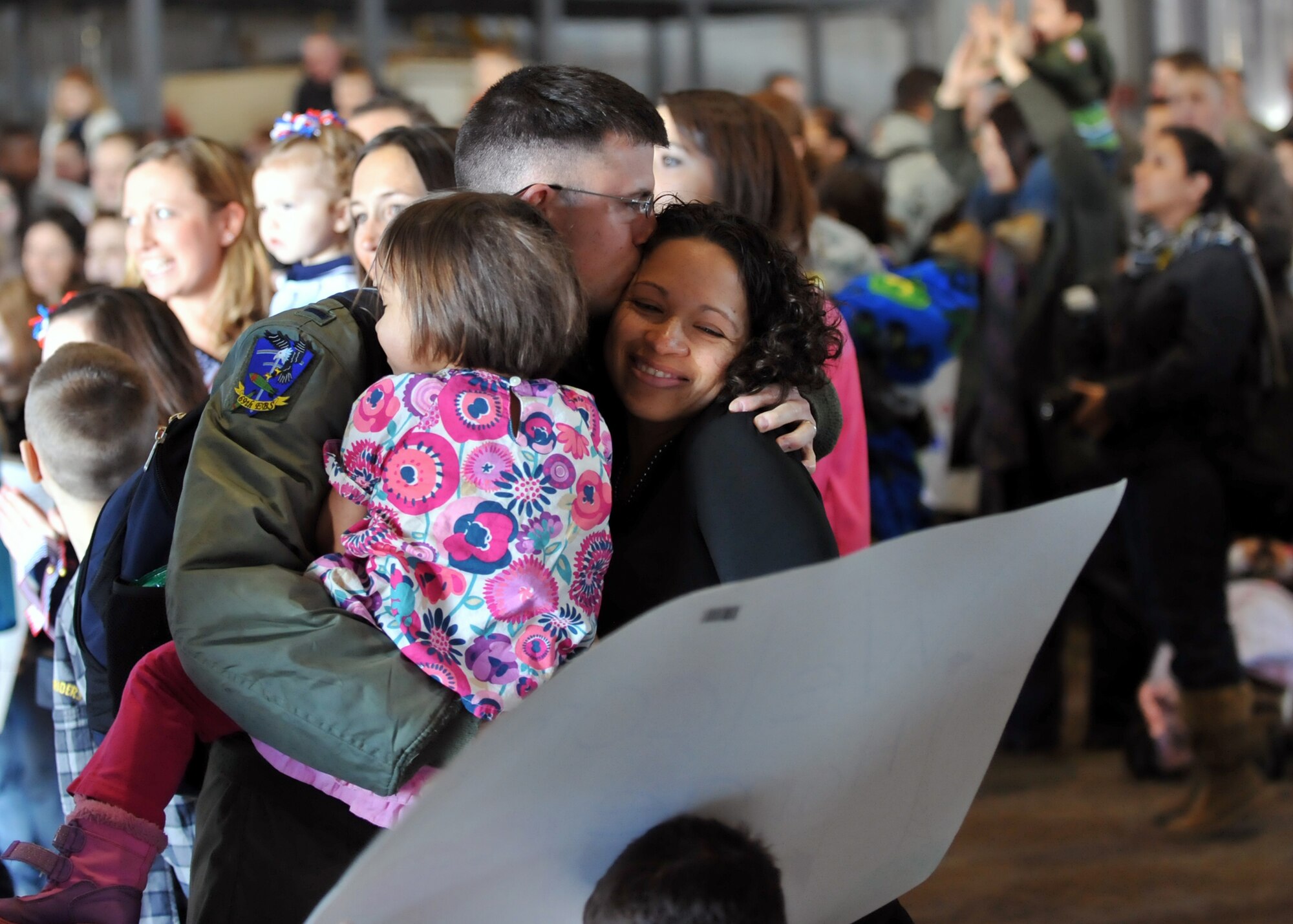 MINOT AIR FORCE BASE, N.D. -- 1st Lt. Jeff Ward, 69th Bomb Squadron navigator, is greeted by his family after returning home from a six month deployment to Andersen AFB, Guam, here April 4. Minot’s 69th Bomb Squadron and 5th Bomb Wing personnel deployed to Andersen AFB last November in support of U.S. Pacific Command’s Continuous Bomber Presence. This was the 69th BS first deployment since it’s reactivation in September 2009 and the first major combat deployment of aircraft and personnel since World War II. (U.S. Air Force photo/Staff Sgt. Keith Ballard)