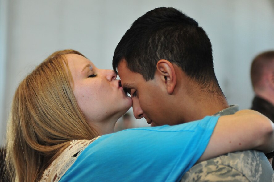 MINOT AIR FORCE BASE, N.D. -- Airman Diego Sanchez Gaona, 5th Aircraft Maintenance Squadron, communication navigation mission systems craftsman, is greeted by his girlfriend after returning home here on April 4. Minot’s 69th Bomb Squadron and 5th Bomb Wing deployed to Andersen AFB, Guam last November in support of U.S. Pacific Command’s Continuous Bomber Presence. This was the 69th BS’ first deployment since it’s reactivation in September 2009 and the first major combat deployment of aircraft and personnel since World War II. (U.S. Air force photo/ Senior Airman Jesse Lopez)