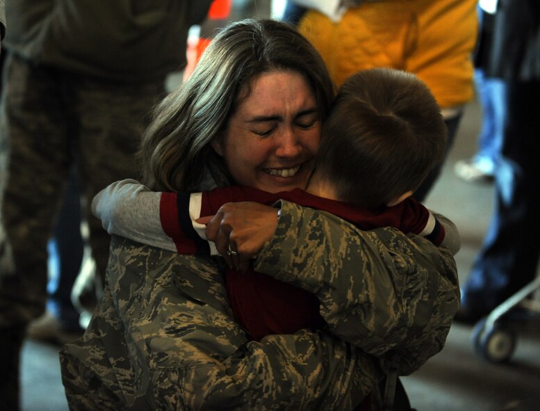 MINOT AIR FORCE BASE, N.D. -- Tech. Sgt. Heather Leavitt, 5th Munitions Squadron crew chief, embraces her son after returning home here on April 4 from a six month deployment to Andersen AFB, Guam. Minot’s 69th Bomb Squadron and 5th Bomb Wing personnel deployed to Andersen AFB last November in support of U.S. Pacific Command’s Continuous Bomber Presence. This was the 69th BS’ first deployment since it’s reactivation in September 2009 and the first major combat deployment of aircraft and personnel since World War II. (U.S. Air Force photo/Airman 1st Class Jose L. Hernandez)