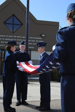 The CAP Cadets participate in folding the flag under the watchful eyes of the three Malmstrom Honor Guard judges; who scored the group very high for their overall performance for the day's events. (U.S. Air Force photo/Airman Cortney Hansen)