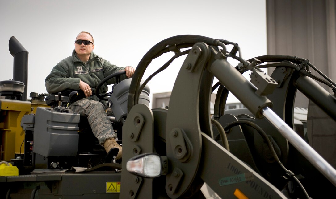 Tech. Sgt. Michael Fletcher sits on a forklift March 20, 2011, at Sendai Airport, Japan. Fletcher is the NCO in charge of the 353rd Special Operations Group's air transportation team. (U.S. Air Force photo/Staff Sgt. Samuel Morse)