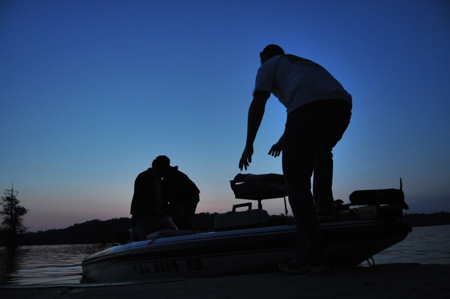 Contestants in the Flag Lake Bass Fishing Tournament push off of a dock at Flag Lake on Barksdale Air Force Base, La., April  2. The contest started at 5:30 a.m. and ended at 1 p.m. The contestants had to be within the tree line by 1 p.m. for their catches to count. (U.S. Air Force photo/ Airman 1st Class Micaiah Anthony)(RELEASED) 