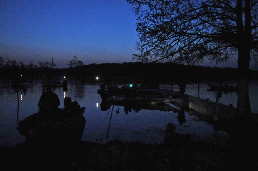 Contestants in the Flag Lake Bass Fishing Tournament wait for the contest to begin at Flag Lake on Barksdale Air Force Base, La., April 2. The contest started at 5:30 a.m. and ended at 1 p.m. The contestants had to be within the tree line by 1 p.m. for their catches to count. (U.S. Air Force photo/ Airman 1st Class Micaiah Anthony)(RELEASED)