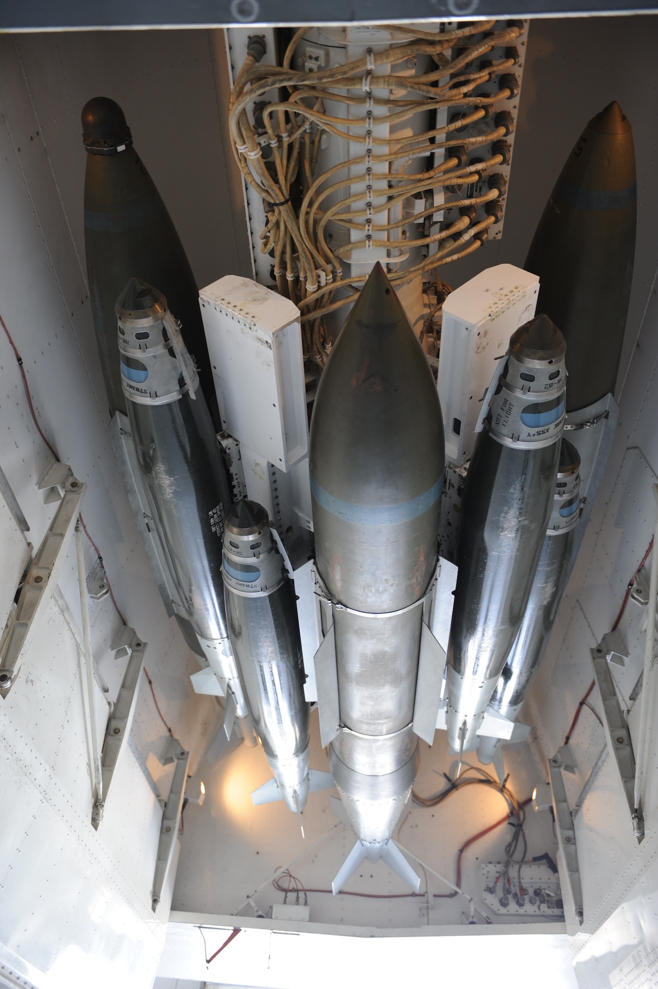 DYESS AIR FORCE BASE, Texas — An assortment of 500-pound and 2,000-pound Joint Direct Attack Munitions are connected to a Multiple Ejector Rack March 31 on a B-1 at the weapons load barn here.  If fielded, a 16-carry modified rotary launcher will increase the number of 500-pound Joint Direct Attack Munitions and Laser Guided JDAMS carried by the B-1 from 15 to 48, a 320 percent increase in capability. (U.S. Air Force photo/ Airman 1st Class Shannon Hall)